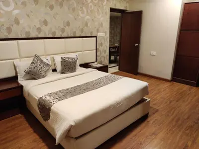 a bedroom with a large bed in a room at Hillcrest Metro in Ooty
