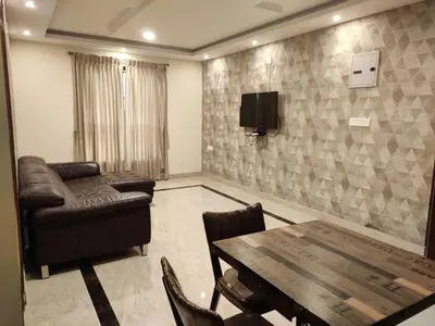 a living room with a couch and a table at Hillcrest Metro in Ooty