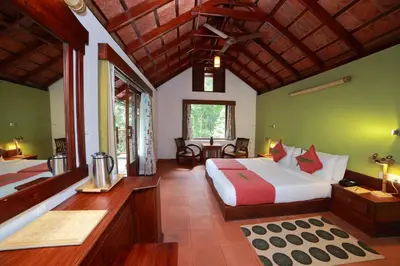 a bedroom with a large bed in a room at Vythiri Resort in Vythiri