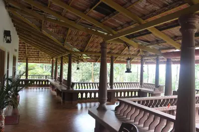 a large room with rows of benches in a building at Wayal Wayanad Twin Villa in Panamaram