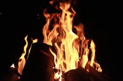 a fire is burning in the dark with flames at Wayal Wayanad Twin Villa in Panamaram