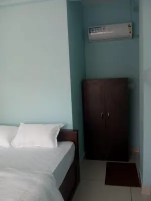 a bedroom with a bed and a air conditioner at ZaMaRaYa Bed & Breakfast in Angamali