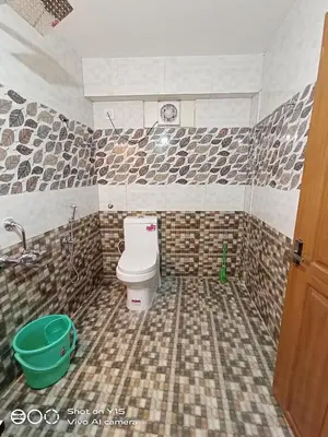 a bathroom with a toilet and a sink and a tub at Hotel Magnet in Marayoor