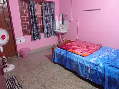 a pink room with a bed and a sink at Dreams River view home stay coorg 2 in Kushālnagar