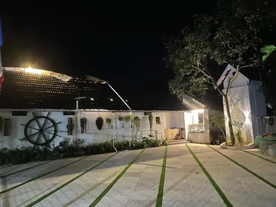 a house at night with a basketball court in front of it at Kayyalas Courtyard in Trichūr