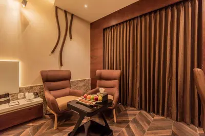a waiting room with two chairs and a table at Hotel Park Elanza Coimbatore in Coimbatore