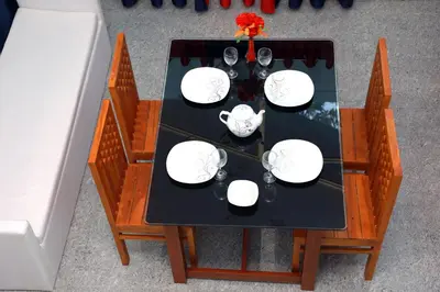 an overhead view of a table with plates and wine glasses at NARMADA HOMESTAY Yamuna in Malappuram