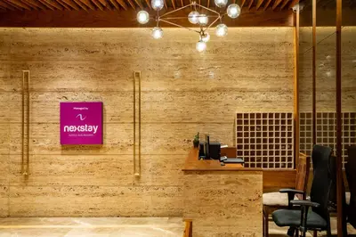 an office with a pink sign on a wall at Nexstay Treats Inn in Kozhikode