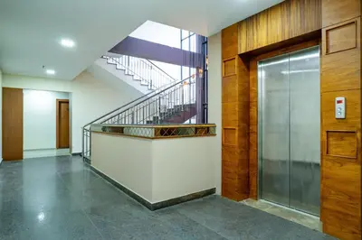 a hallway with a staircase in a building at Nexstay Treats Inn in Kozhikode