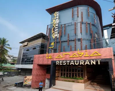 a building with a sign that reads la acropolis restaurant at Nexstay Treats Inn in Kozhikode