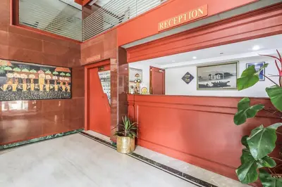 a lobby of a restaurant with red walls at Fort Gate Hotels & Resorts in Trichūr