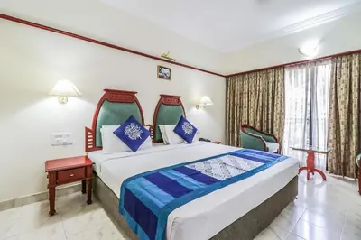 a bedroom with a large bed in a room at Fort Gate Hotels & Resorts in Trichūr