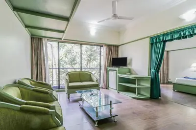 a living room with a couch and a table at Fort Gate Hotels & Resorts in Trichūr