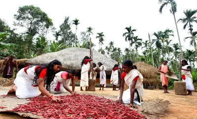 a group of people cutting up red peppers at The Woods Resorts Wayanad in Sultan Bathery