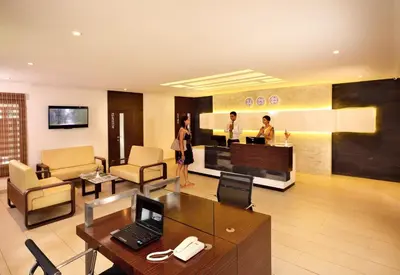 a lobby with people standing in a room at The Woods Resorts Wayanad in Sultan Bathery