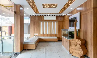 a room with a guitar and a fish tank at Treebo Four Seasons in Mysore