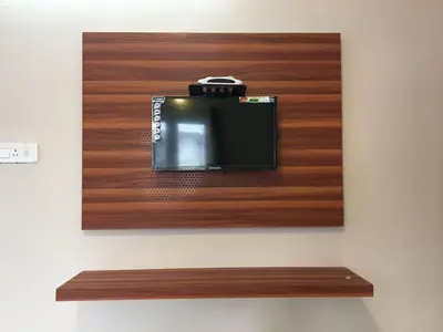 a small television on a wall with a camera on it at HAPPYSTAY rooms and cottages in Ooty