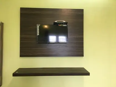 a camera hanging on a wall with a shelf at HAPPYSTAY rooms and cottages in Ooty