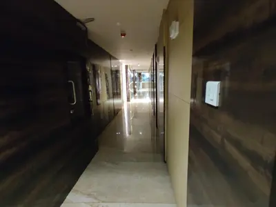 an empty hallway of a building with a hallway at Neermala Residency in Coimbatore