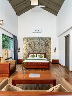 a bedroom with a bed and a table at Coffee Greens Resort in Wayanad