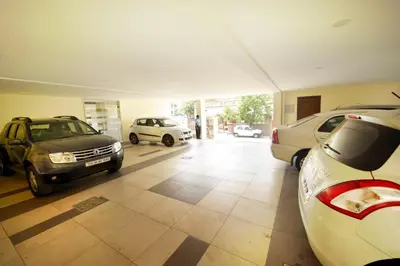 a garage with three cars parked in it at HOTEL THE FORTUNE in Coimbatore