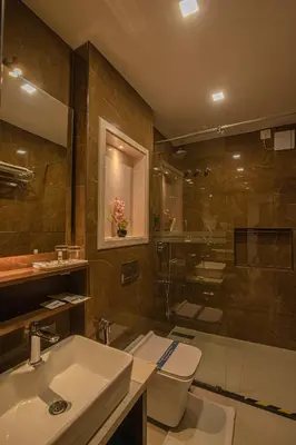 a bathroom with a sink and a shower and a toilet at Windstone Residency in Coimbatore