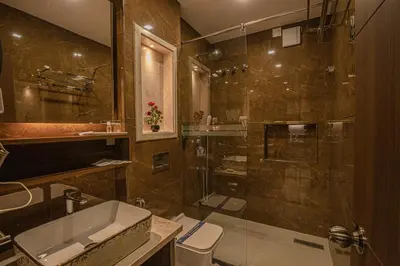a bathroom with a shower and a sink and a toilet at Windstone Residency in Coimbatore