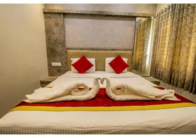 a bed with two swans made out of towels at SR BOUTIQUEE STAY in Coimbatore