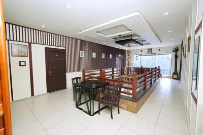 a dining room with a table and chairs at Velan Temple View in Palani
