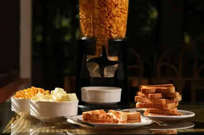 a table topped with plates of bread and other foods at Zostel Homes Wayanad, Thirunelly in Wayanad