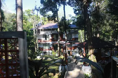 a large building in the middle of a forest at VANYA by Citrine in Nelliyampathy