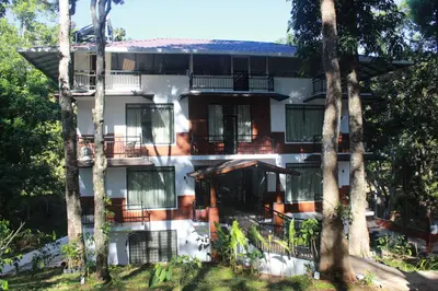 a building with trees in front of it at VANYA by Citrine in Nelliyampathy