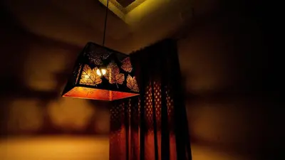 a chandelier hanging from the ceiling of a room at Sarvam Serviced Apartment in Coimbatore