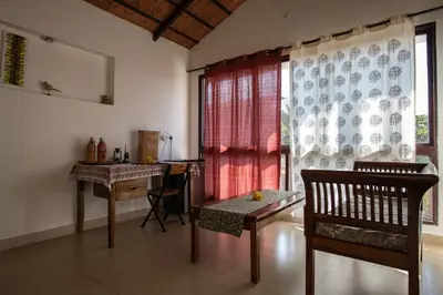 a room with a table and a chair and a window at Dhole's Den Bandipur in Bandipūr