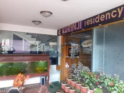 a store with potted plants in front of a window at kurinji residency in Ooty