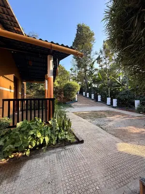 a brick walkway next to a building with plants at Wayanad Cocos Villa in Tariyod