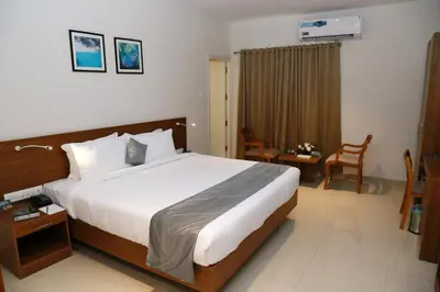 a bedroom with a large bed in a hotel room at Hotel Picnic in Manjeri
