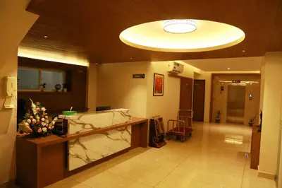 a lobby with a reception desk in a building at Hotel Picnic in Manjeri
