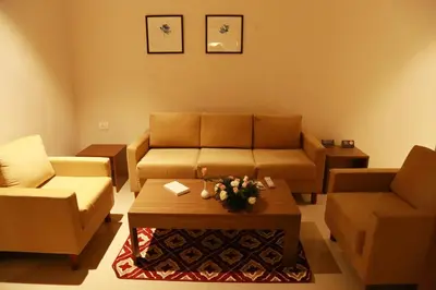 a living room with a couch and a coffee table at Hotel Picnic in Manjeri