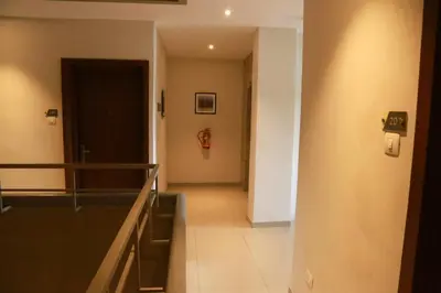 a hallway with a door and a stairway at Hotel Picnic in Manjeri