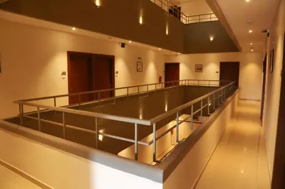 a large empty room with a balcony in a building at Hotel Picnic in Manjeri