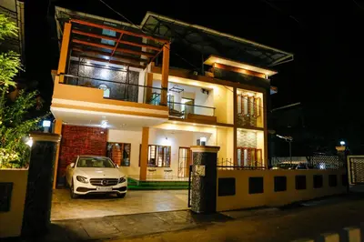 a car parked in front of a house at night at Belljem Homes -your own private resort -3 BHK FF in Trichūr