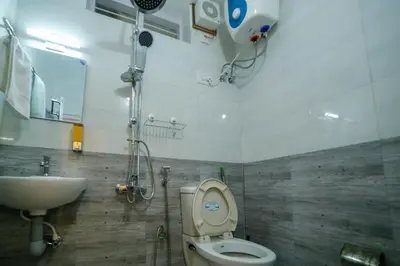 a bathroom with a toilet and a sink at Belljem Homes -your own private resort -3 BHK FF in Trichūr