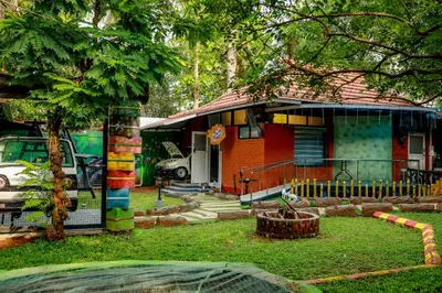 a small house with a tree in front of it at Belljem Homes -your own private resort -3 BHK FF in Trichūr
