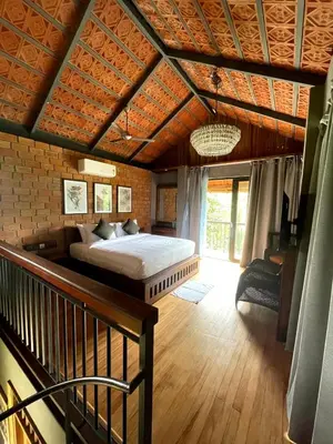 a bedroom with a bed in a room at BARSATI Ranches in Vythiri