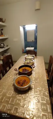 a table with plates of food on top of it at the motville - Serene Family Retreat & Private Pool in Pulpally