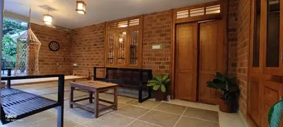 a porch with a bench and a brick wall at the motville - Serene Family Retreat & Private Pool in Pulpally
