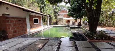 a pool of water in front of a house at the motville - Serene Family Retreat & Private Pool in Pulpally