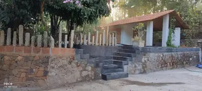 a small house with a stone wall and a fence at the motville - Serene Family Retreat & Private Pool in Pulpally