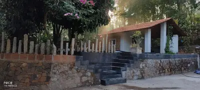 a small house with a stone wall and a fence at the motville - Serene Family Retreat & Private Pool in Pulpally